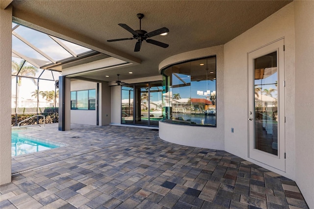 view of patio with ceiling fan and a lanai