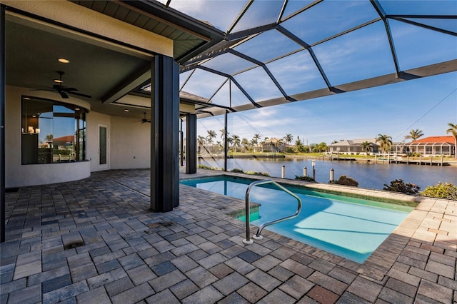 view of pool featuring a lanai, ceiling fan, a water view, and a patio