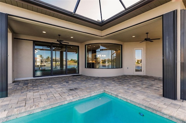 view of swimming pool featuring a patio area and ceiling fan