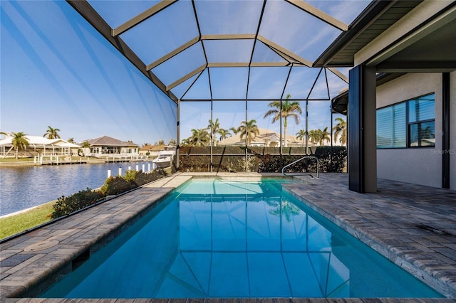 view of pool with a patio, a water view, and a lanai