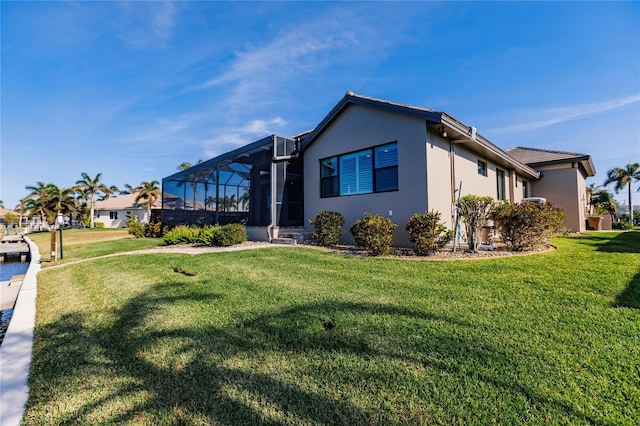 view of front of house with a front lawn and a lanai