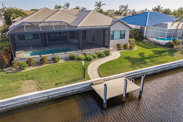 back of house featuring a lawn, a lanai, a water view, and a patio