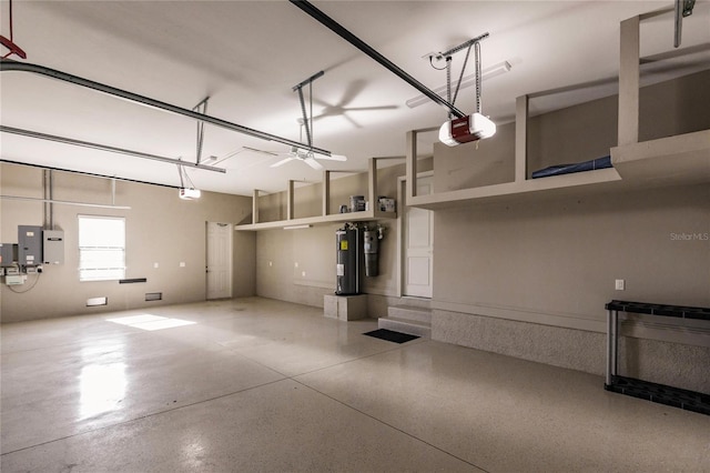 garage featuring electric panel, electric water heater, and a garage door opener