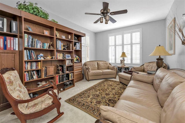 living room with ceiling fan, a healthy amount of sunlight, and light colored carpet