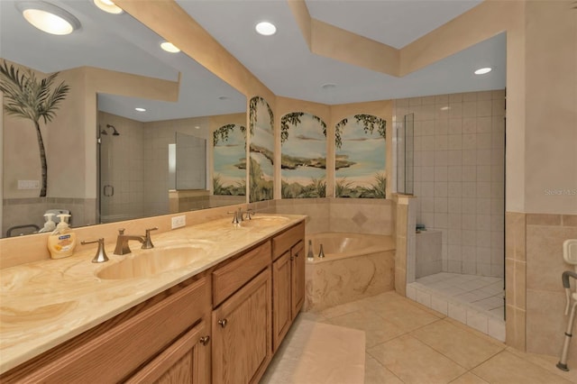 bathroom with tile patterned flooring, vanity, tile walls, and shower with separate bathtub