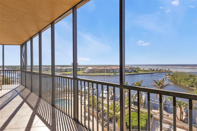 unfurnished sunroom with a water view