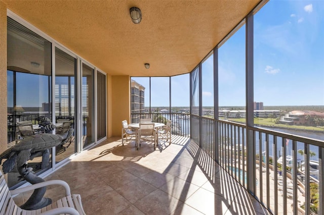 unfurnished sunroom with a water view