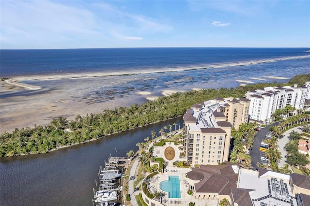 drone / aerial view with a water view and a beach view