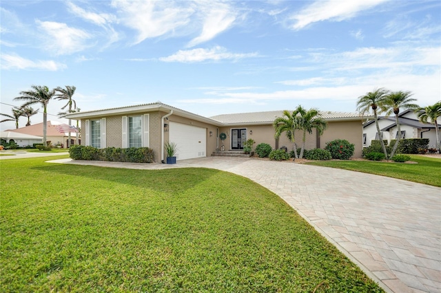 ranch-style home featuring a garage and a front lawn