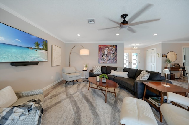 living room with ceiling fan, crown molding, and french doors