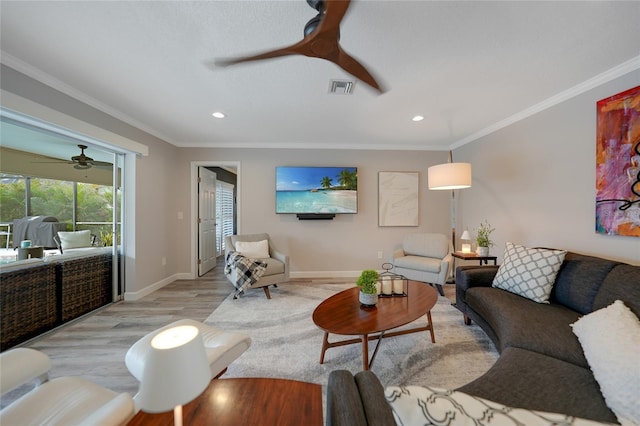 living room with light hardwood / wood-style flooring, ceiling fan, and ornamental molding