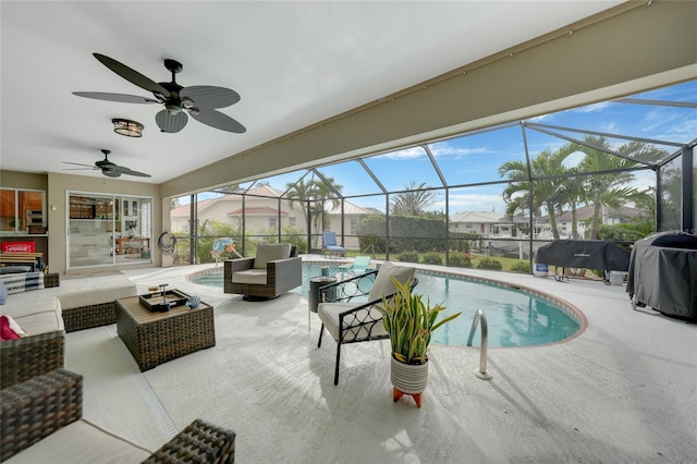 view of swimming pool with an outdoor hangout area, ceiling fan, glass enclosure, a patio, and a grill