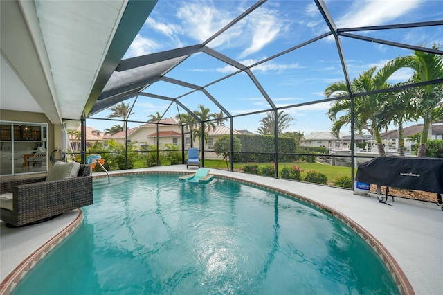 view of swimming pool featuring a patio and glass enclosure