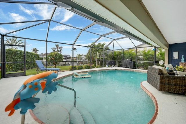 view of pool featuring grilling area and a lanai