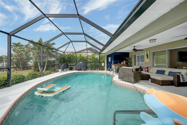 view of swimming pool featuring a lanai, outdoor lounge area, ceiling fan, and a patio