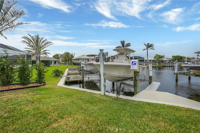 dock area with a yard and a water view