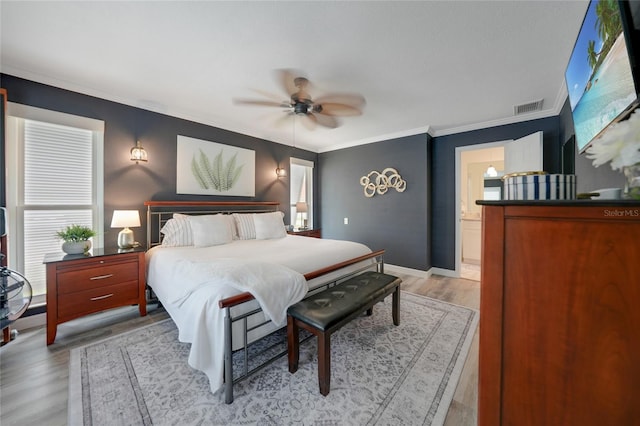 bedroom with ensuite bath, ceiling fan, ornamental molding, and light wood-type flooring