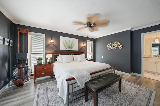 bedroom featuring wood-type flooring, ensuite bath, ceiling fan, and crown molding