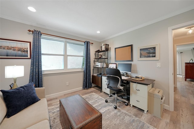 office area with light hardwood / wood-style floors and crown molding