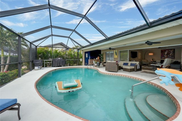 view of swimming pool featuring a lanai, outdoor lounge area, ceiling fan, and a patio area