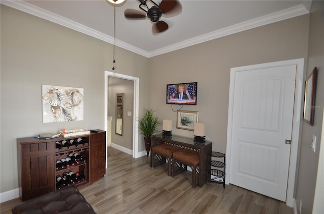 interior space featuring crown molding, ceiling fan, and wood-type flooring