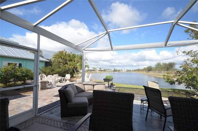 sunroom featuring a water view