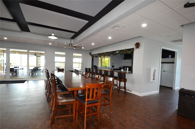 dining area with ceiling fan and dark wood-type flooring