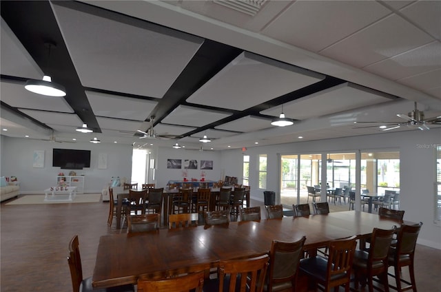 dining area with beam ceiling and ceiling fan