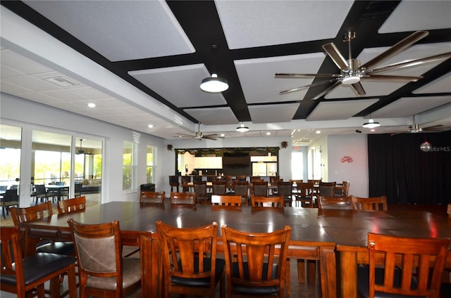 dining space featuring beam ceiling and coffered ceiling