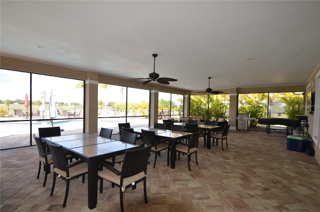 sunroom / solarium featuring ceiling fan