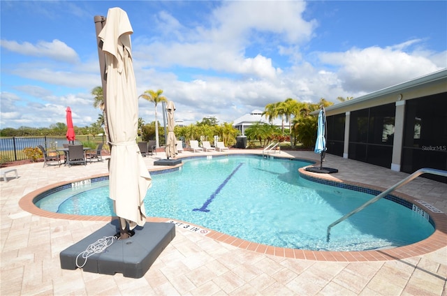 view of swimming pool featuring a patio area