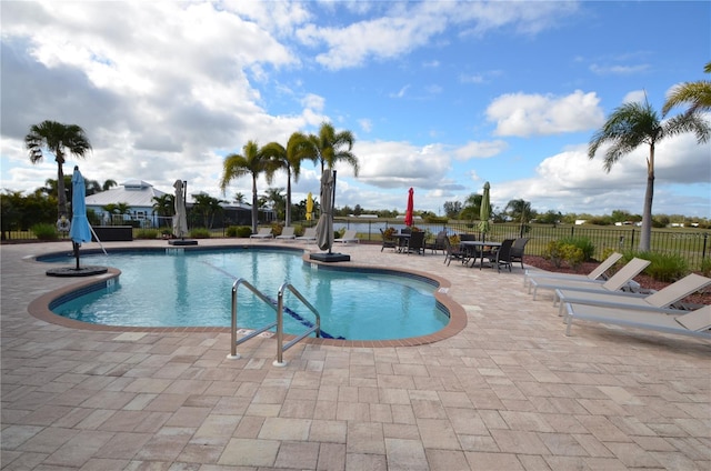 view of swimming pool featuring a patio area