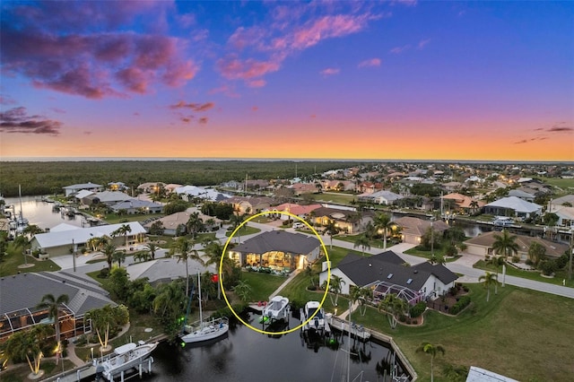 aerial view at dusk with a water view