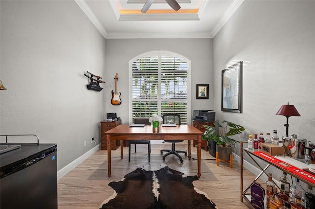 office with a raised ceiling, ceiling fan, light hardwood / wood-style flooring, and ornamental molding