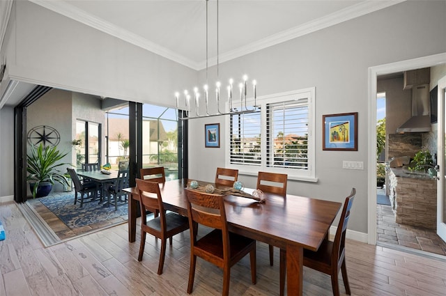 dining area with ornamental molding, a notable chandelier, and hardwood / wood-style flooring