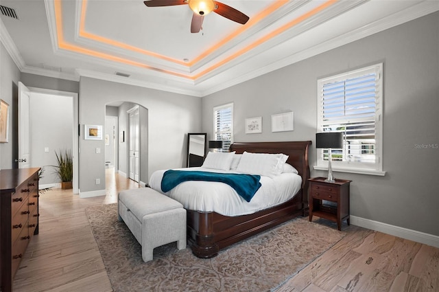 bedroom featuring light hardwood / wood-style floors, multiple windows, and ceiling fan