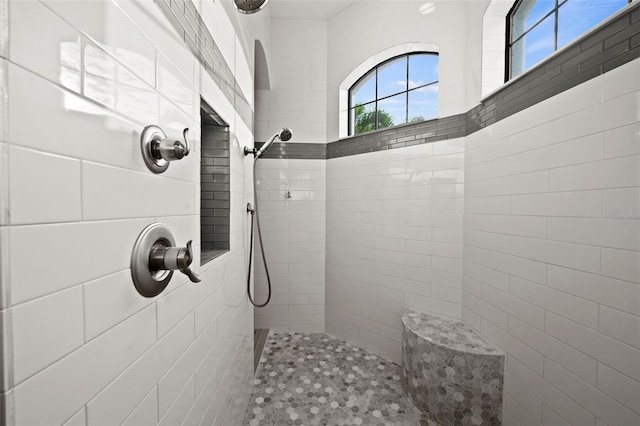 bathroom featuring a tile shower