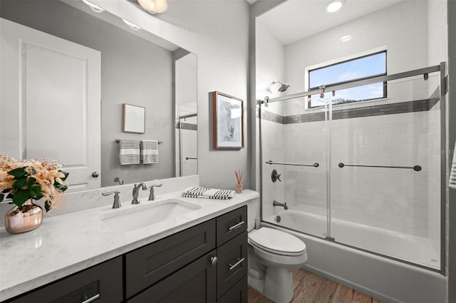 full bathroom with toilet, vanity, enclosed tub / shower combo, and hardwood / wood-style flooring