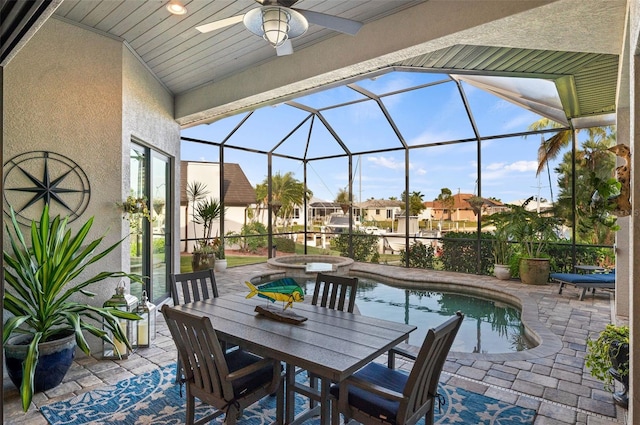 view of patio featuring a swimming pool with hot tub, glass enclosure, and ceiling fan