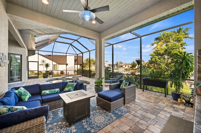 view of patio / terrace with an in ground hot tub, an outdoor living space, ceiling fan, and a lanai