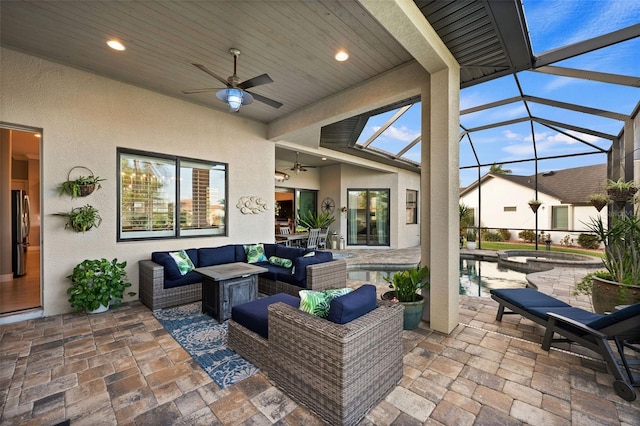 view of patio with outdoor lounge area, ceiling fan, and a lanai