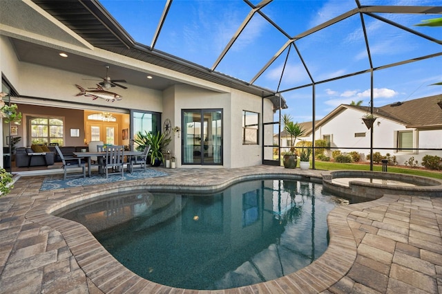 view of pool featuring french doors, ceiling fan, a lanai, an in ground hot tub, and a patio