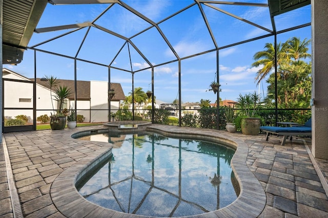 view of pool with a lanai, an in ground hot tub, and a patio