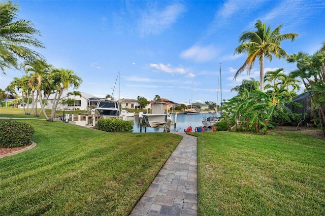 dock area with a water view and a yard