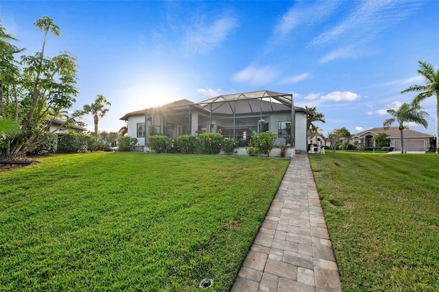 exterior space with a lanai and a lawn