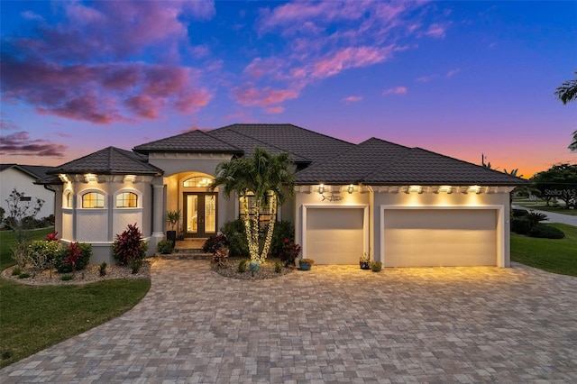 view of front of home with french doors and a garage