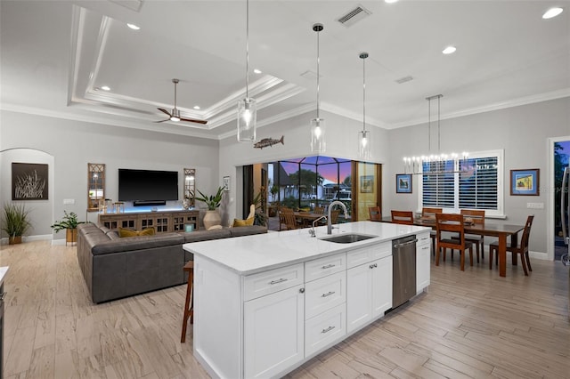 kitchen with ceiling fan with notable chandelier, sink, decorative light fixtures, a center island with sink, and white cabinets