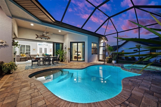 pool at dusk featuring an outdoor living space, french doors, ceiling fan, an in ground hot tub, and a patio