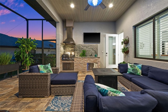 view of patio with outdoor lounge area, ceiling fan, grilling area, and exterior kitchen