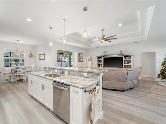 kitchen featuring white cabinets, a raised ceiling, sink, decorative light fixtures, and dishwasher